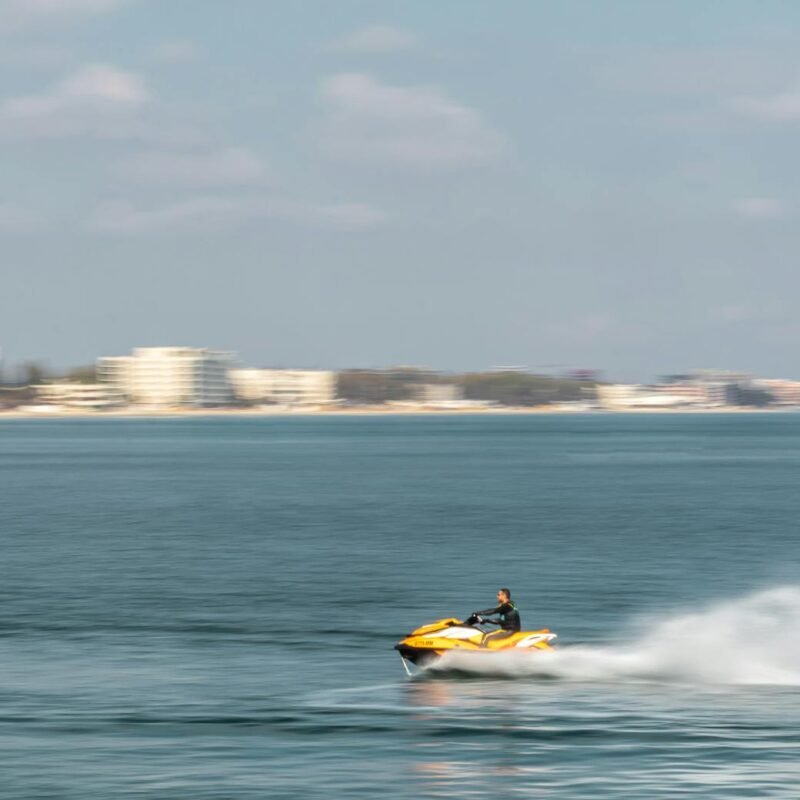 man riding a jet ski on body of water