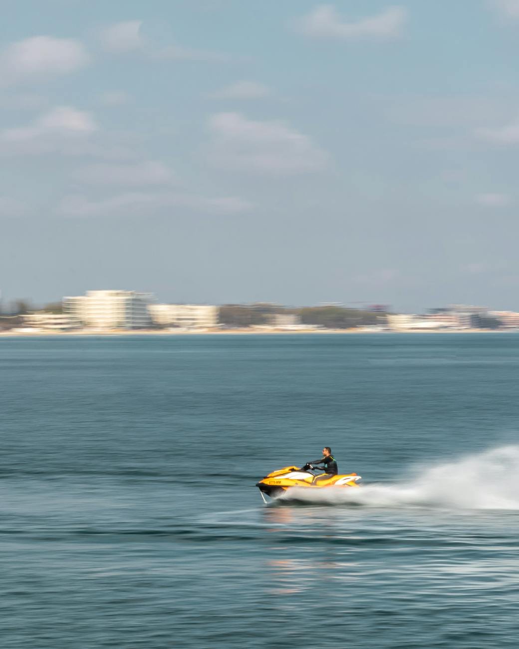 man riding a jet ski on body of water