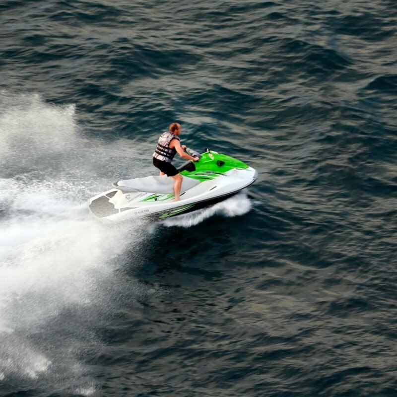 man riding jet ski on ocean waters at speed